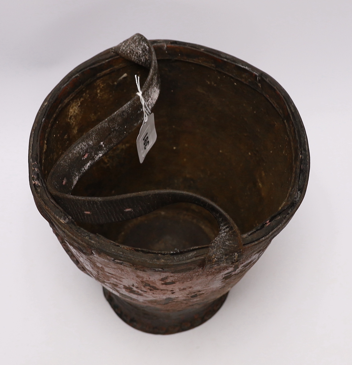 A painted leather fire bucket with armorial crest, 29cm high